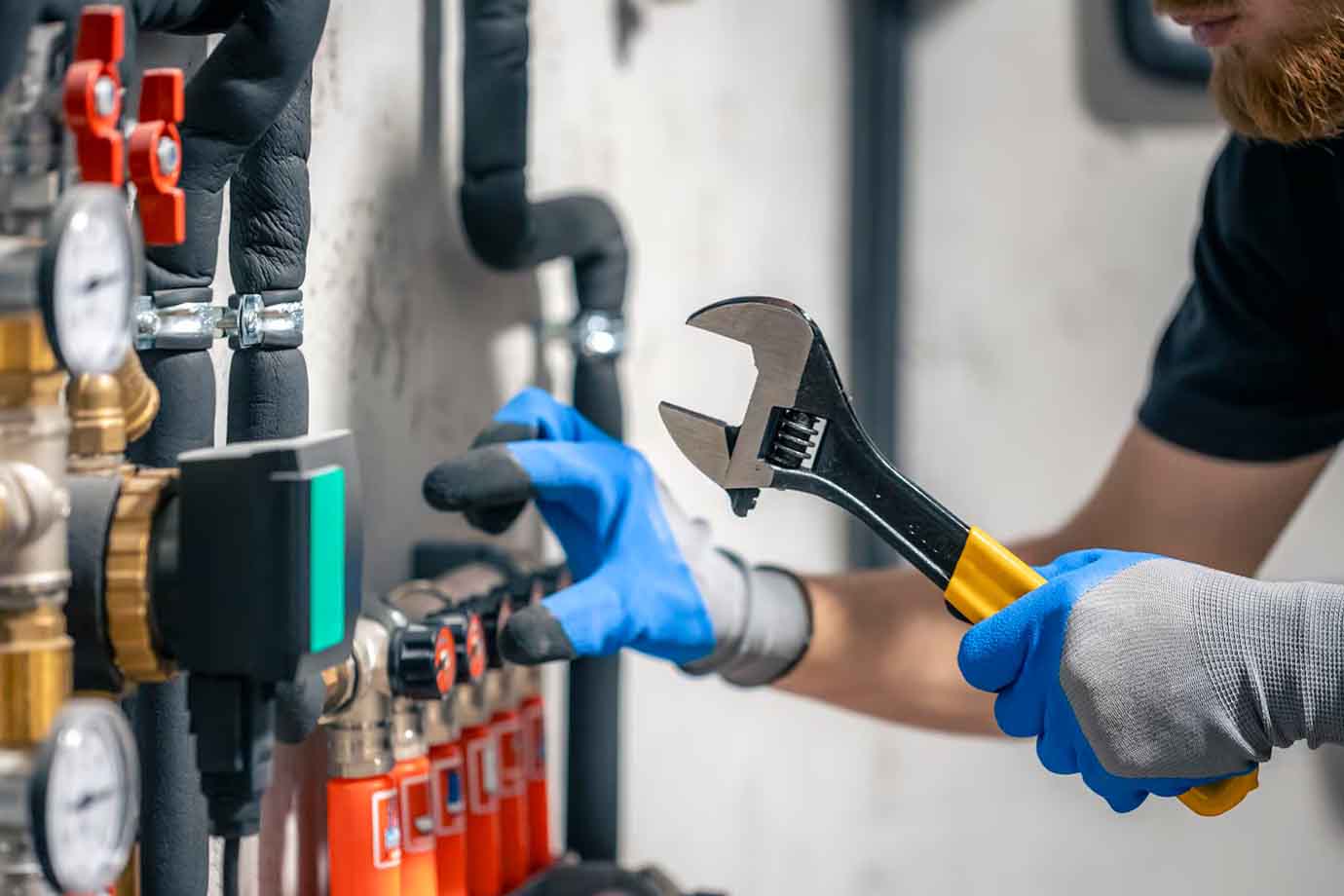 Plumber working with plumbing Emergency, holding plumbing wrench